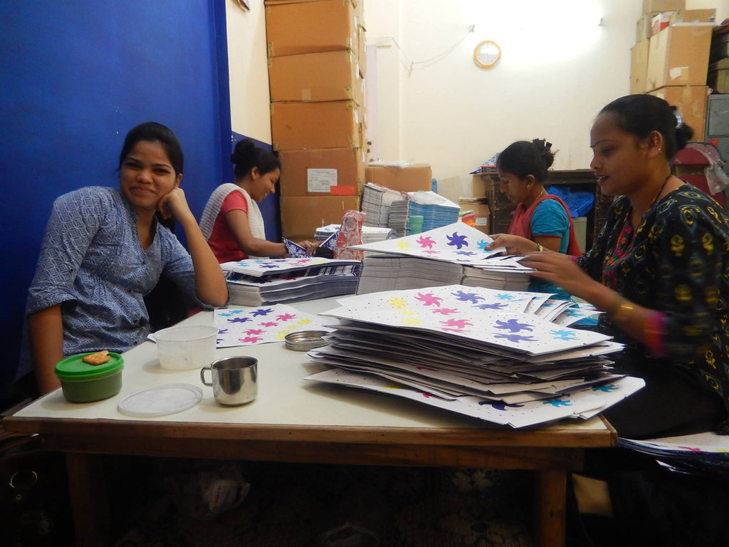 A picture of for ladies making the paper starts for Paperstarlight.