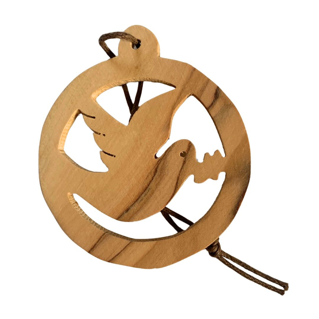 A circular decoration featuring a dove of peace with olive branch in its mouth, made from olive wood which has a distinct and beautiful grain, making no two quite the same. Dimensions 5.5cm x 5.5 cm. Made in Bethlehem.