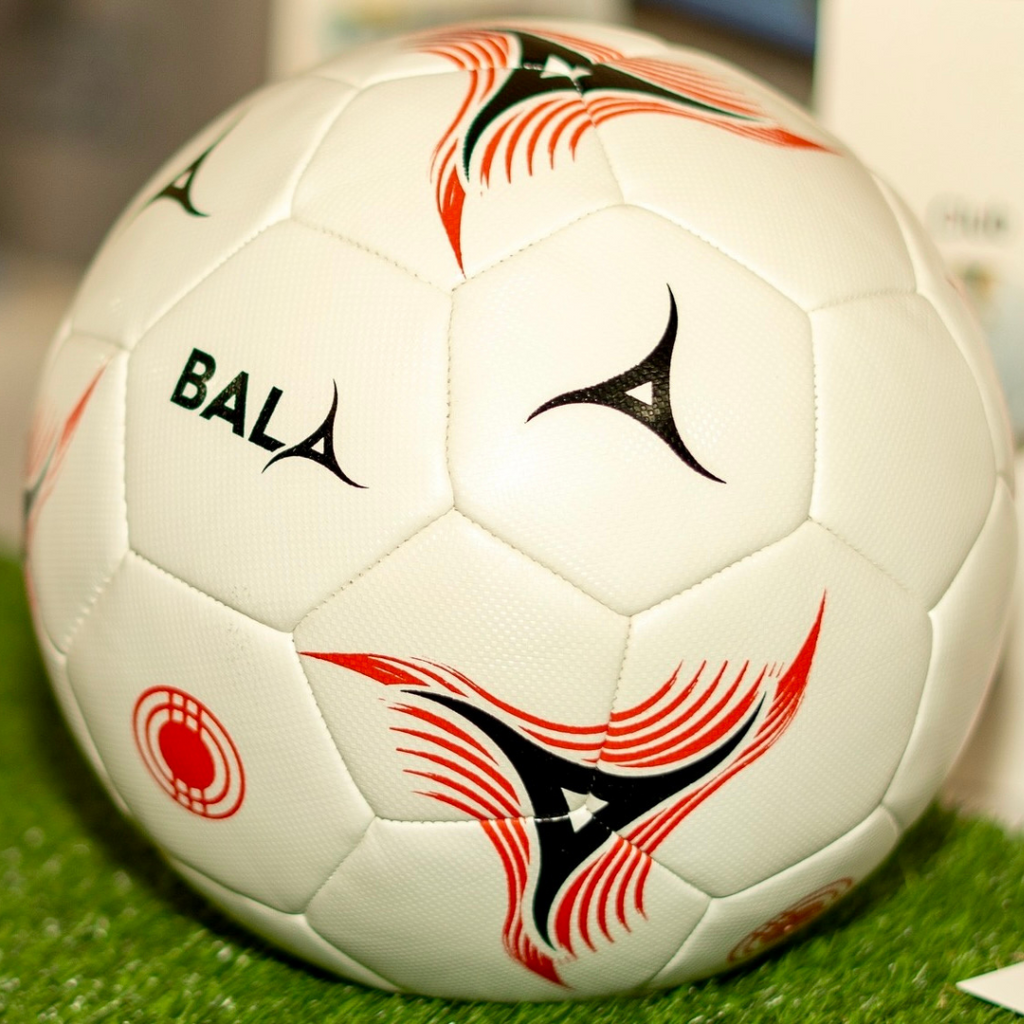 White Bala Team football with red and black pattern.