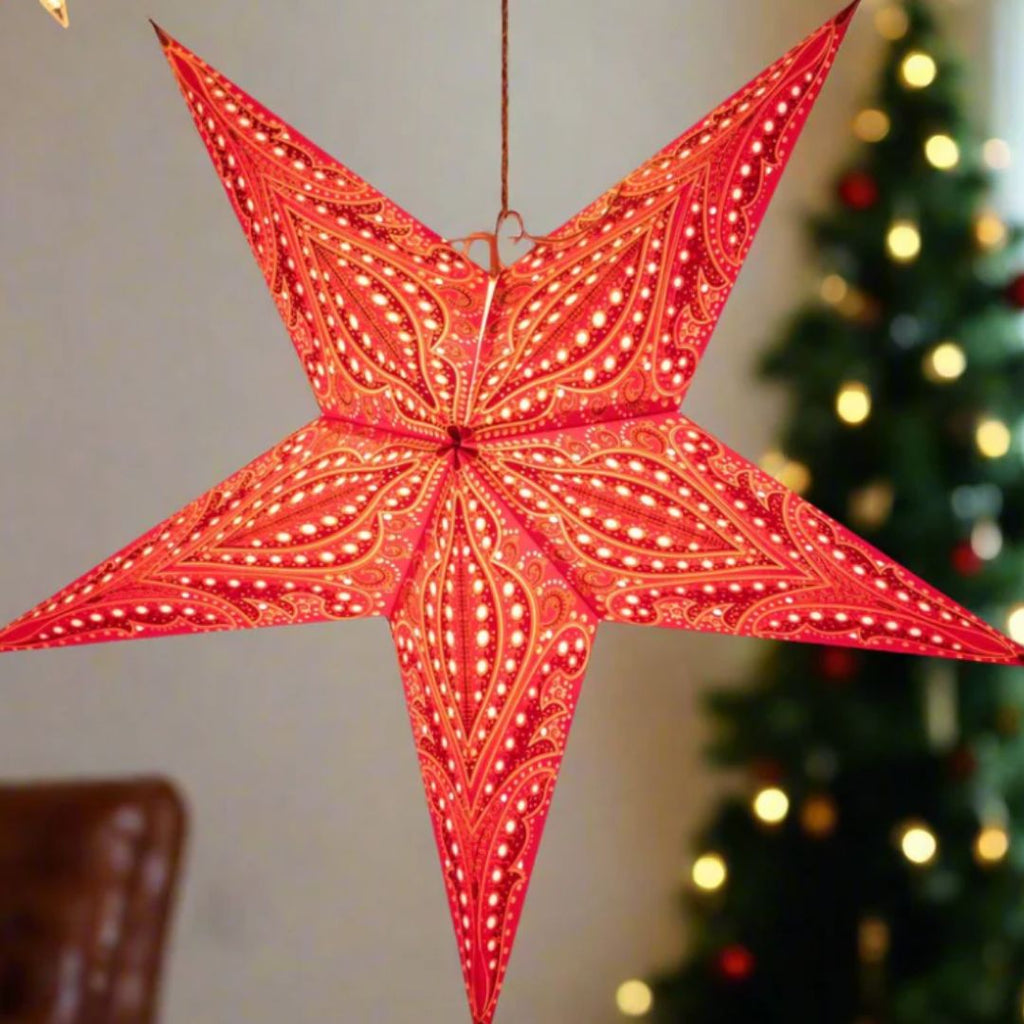 Red star-shaped lantern with intricate design made from using layers of tissue paper. Made in India. Paper Starlights Fantasia Scarlet.